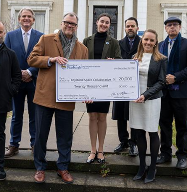 photo of University of Pittsburgh staff accepting donor check